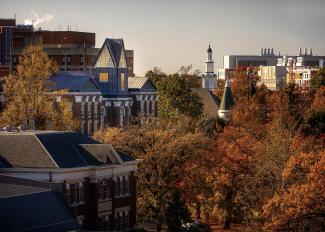 Campus buildings peek over fall foliage